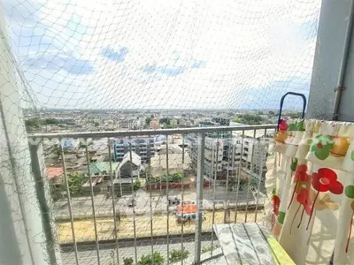 Stunning balcony view overlooking cityscape with safety netting and vibrant decor.