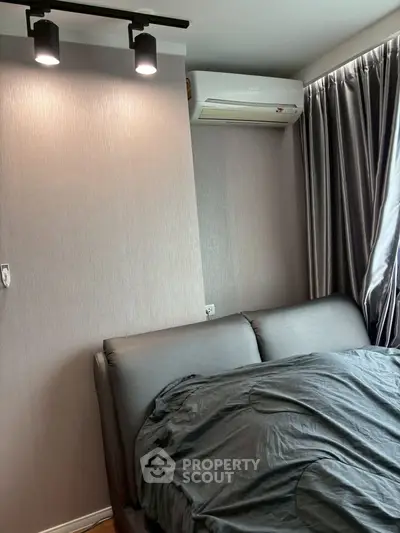 Modern bedroom with sleek design featuring air conditioning and stylish lighting.