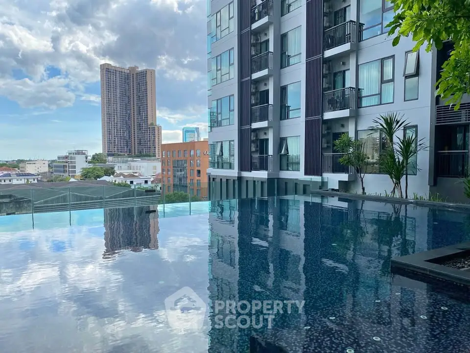 Luxurious high-rise building with stunning rooftop pool and city views.