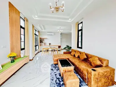 Spacious modern living room with luxurious brown sofa and elegant dining area
