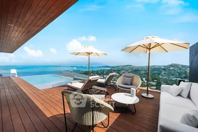Luxurious rooftop terrace with stunning ocean view and infinity pool, perfect for relaxation and entertainment.
