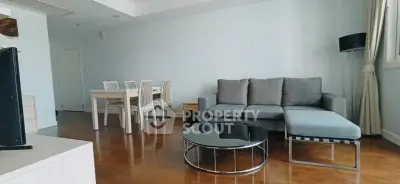 Spacious living room with modern furniture and dining area, perfect for relaxation and entertaining.