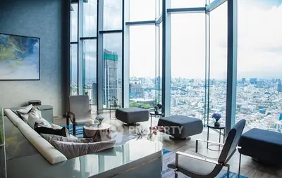 Luxurious high-rise living room with panoramic city views and modern decor.