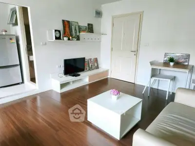 Modern living room with sleek furniture and wooden flooring in a stylish apartment.