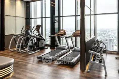 Luxurious high-rise gym with panoramic city views and modern fitness equipment.