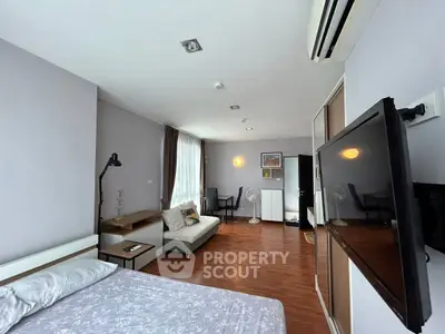 Spacious modern bedroom with cozy living area and stylish decor