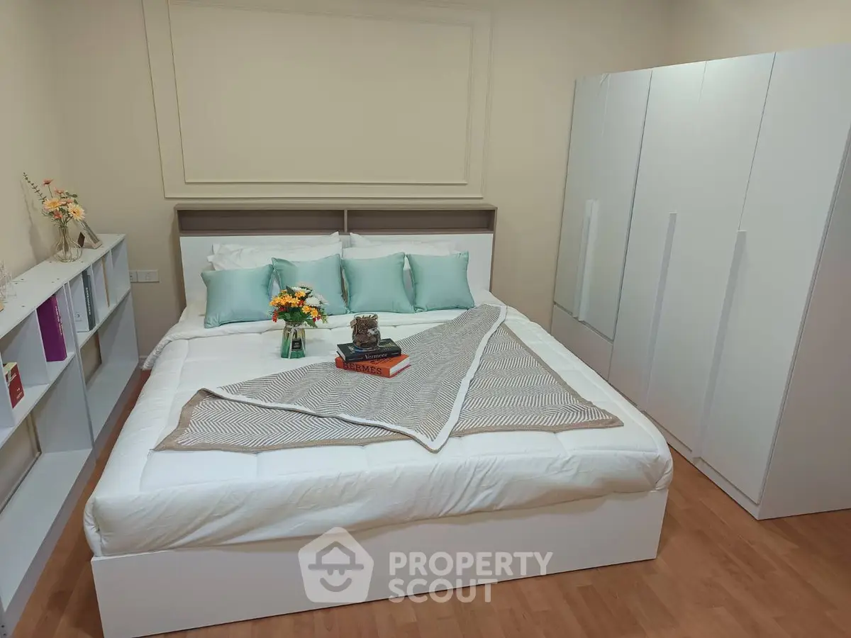 Cozy bedroom with modern white furniture and elegant decor, perfect for relaxation and comfort.