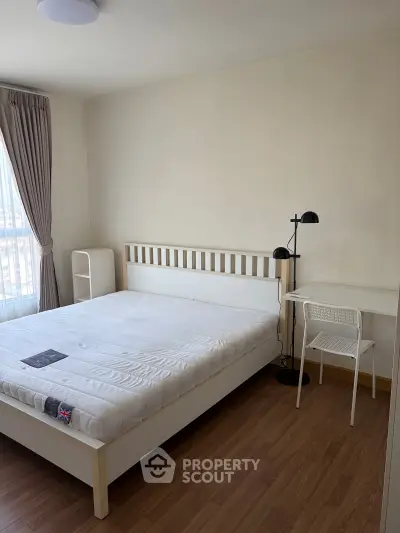 Spacious bedroom with modern furnishings and natural light, perfect for comfortable living.
