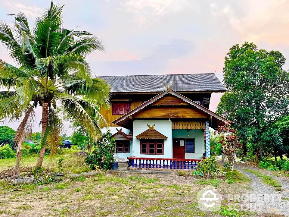 Charming traditional house with lush garden and tropical trees, perfect for serene living.