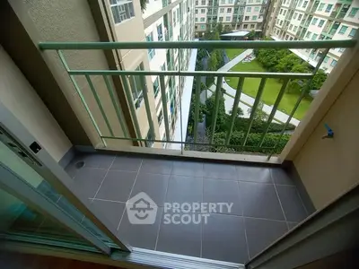 Charming balcony with garden view in modern apartment complex