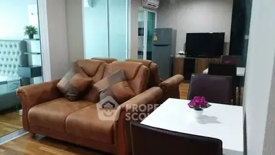 Modern living room with leather sofa and dining area in stylish apartment