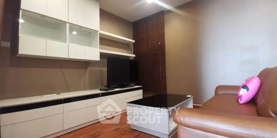 Cozy living room with modern furniture and warm lighting, perfect for relaxation.