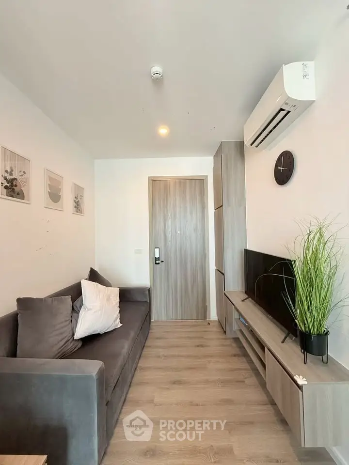 Modern living room with sleek furniture and air conditioning in a stylish apartment.