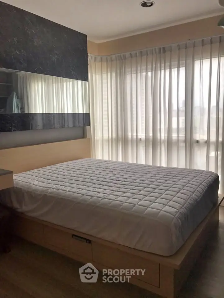 Modern bedroom with large windows and stylish decor