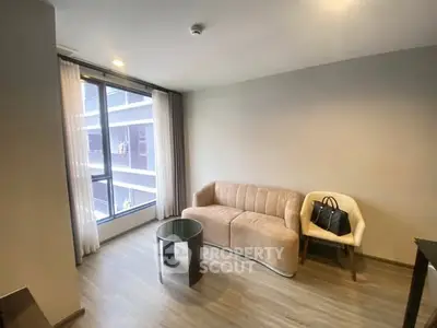 Modern living room with stylish furniture and large window view