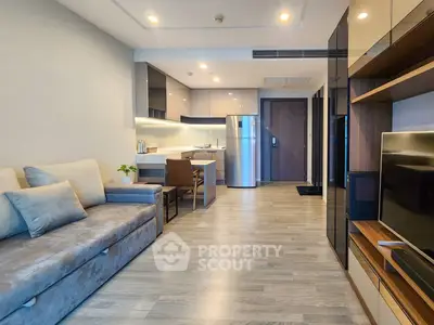Modern open-plan living room with sleek kitchen and stylish decor