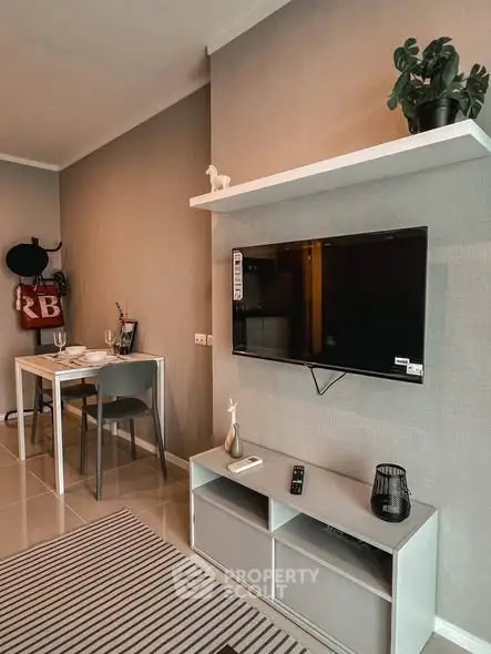 Modern living room with sleek TV setup and stylish dining area