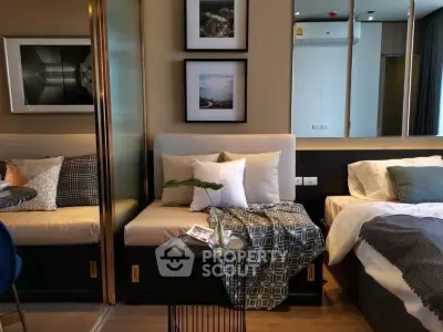 Stylish modern bedroom with cozy seating area and elegant decor