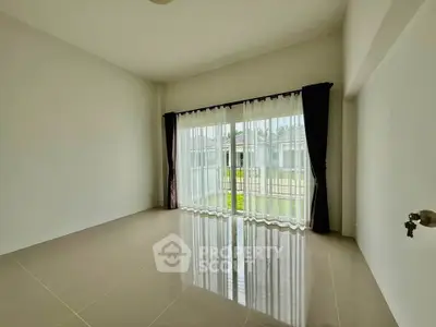 Spacious empty room with large window and garden view, perfect for customization.