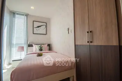 Cozy bedroom with modern decor and ample natural light