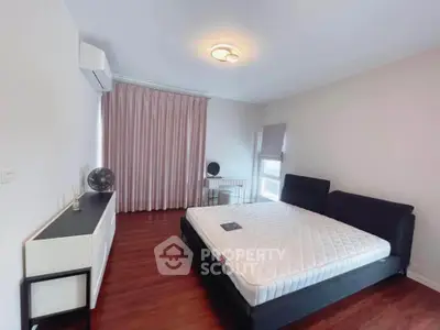 Spacious bedroom with modern furnishings and natural light