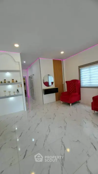 Luxurious modern living room with marble flooring and elegant red armchairs