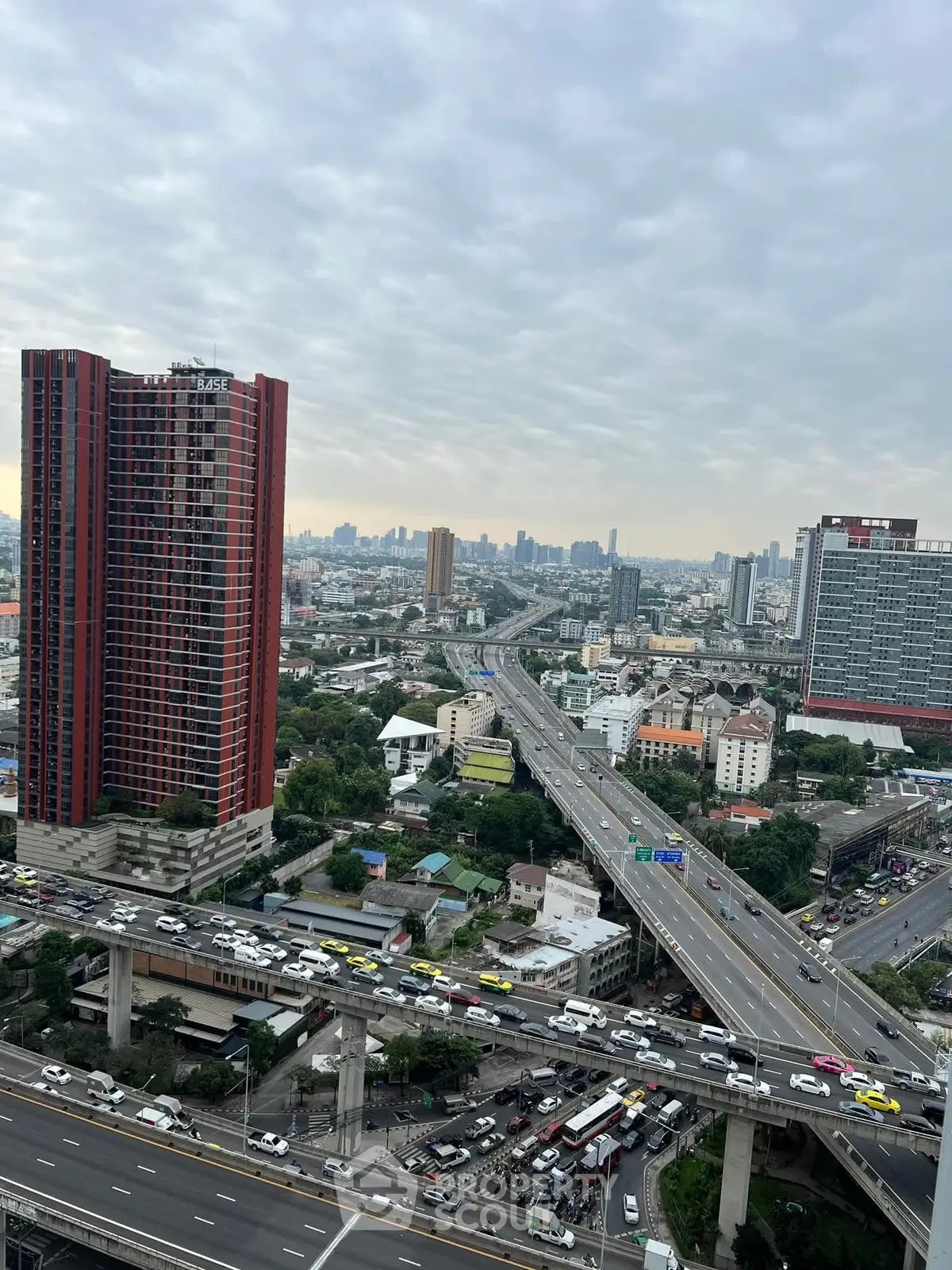 Stunning cityscape view with high-rise buildings and busy highways, perfect for urban living.