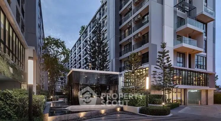 Modern condominium exterior with lush landscaping and elegant architecture.