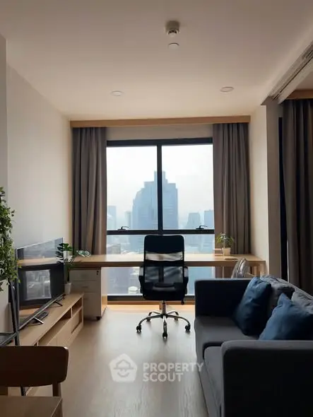 Modern living room with city view, stylish furniture, and natural light.