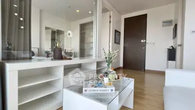 Modern living room with stylish decor and wooden flooring in a contemporary apartment.