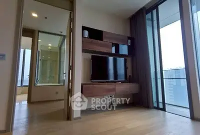 Modern living room with sleek TV unit and balcony view