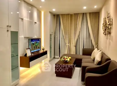 Elegant living room with modern furniture and stylish decor, featuring a cozy sectional sofa and ambient lighting.
