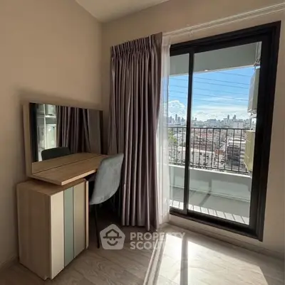 Bright bedroom with city view and balcony access, featuring a stylish vanity desk.