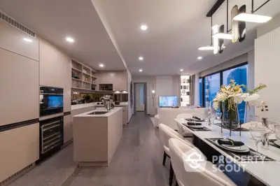 Luxurious open-layout kitchen and dining area with modern appliances and elegant decor.