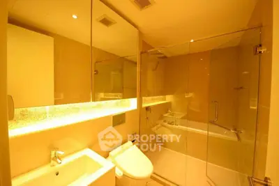 Luxurious modern bathroom with glass shower and ambient lighting