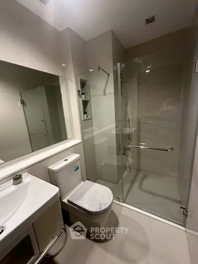 Modern bathroom with glass shower and sleek fixtures