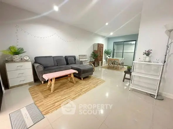 Spacious living room with modern decor and dining area, perfect for family gatherings.
