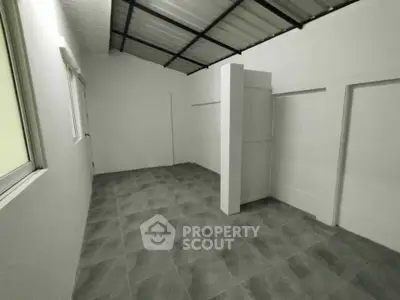 Spacious storage room with tiled flooring and modern design, perfect for organizing and maximizing space.