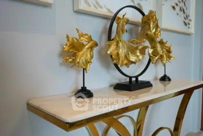 Elegant interior decor with gold fish sculptures on a marble console table.