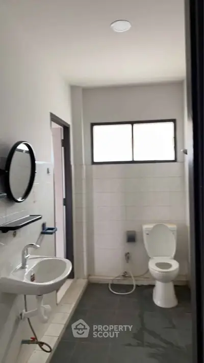 Modern bathroom with sleek fixtures and natural light, perfect for a contemporary home.