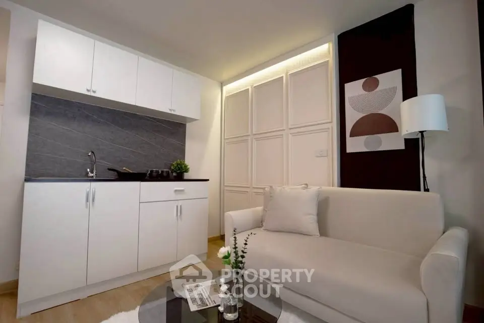Modern studio apartment with sleek kitchenette and cozy living area, perfect for urban living.