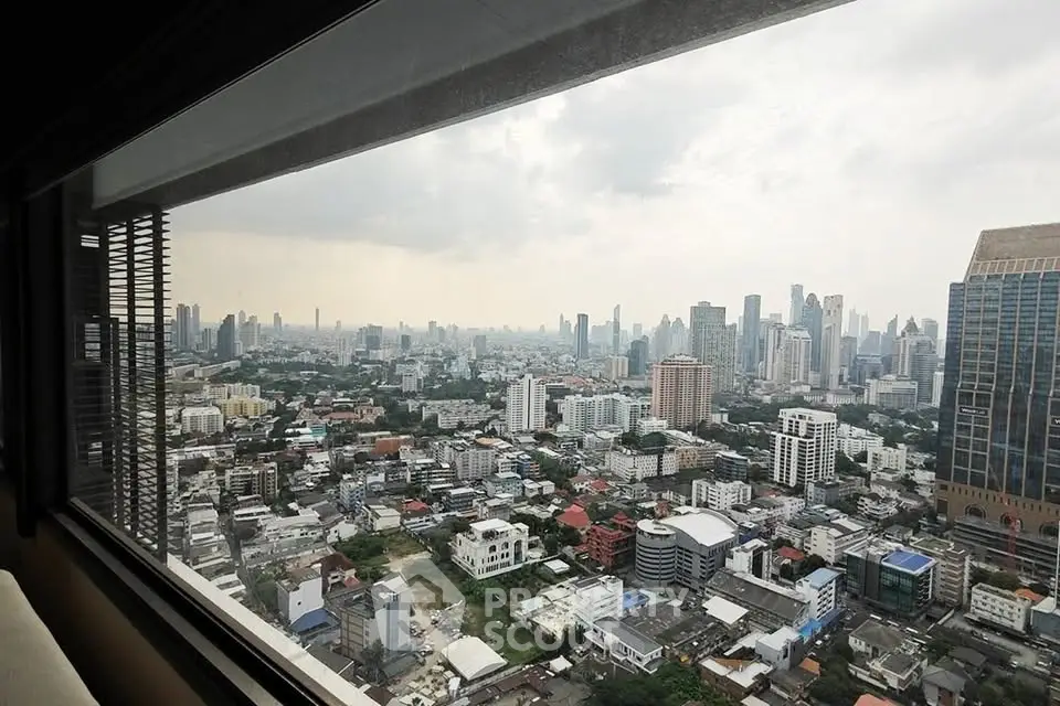 Stunning cityscape view from a high-rise window showcasing urban skyline and architecture.