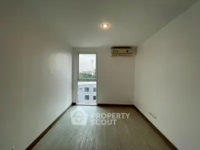 Minimalist bedroom with air conditioning and natural light