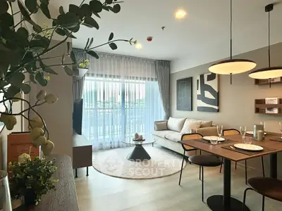Stylish modern living room with cozy seating and elegant dining area, perfect for urban living.