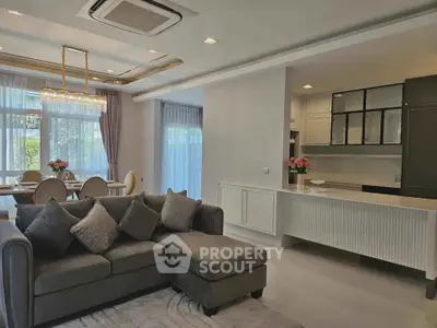 Luxurious open-plan living room with elegant dining area and modern kitchen.