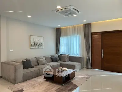 Modern living room with stylish gray sofa and elegant decor