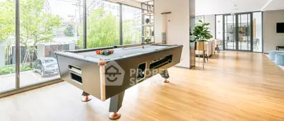 Spacious modern living area with pool table and large windows