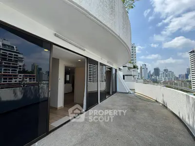 Spacious balcony with stunning city views in modern high-rise apartment