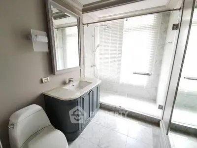 Elegant bathroom with modern fixtures and large glass shower enclosure