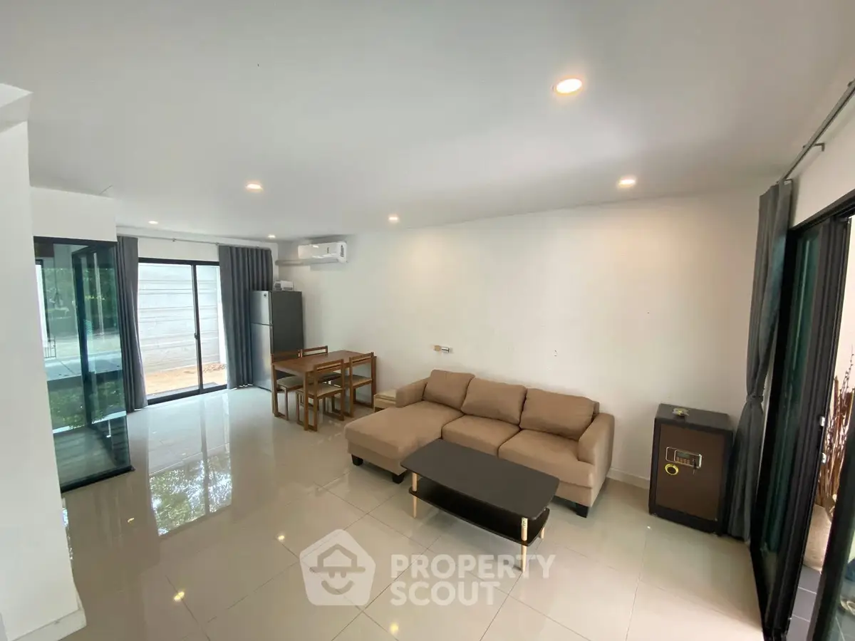 Spacious modern living room with sleek furniture and large windows for natural light.